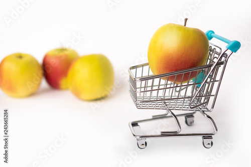 Fototapeta Naklejka Na Ścianę i Meble -  Healthy food and proper nutrition.  Apple in a shopping cart.