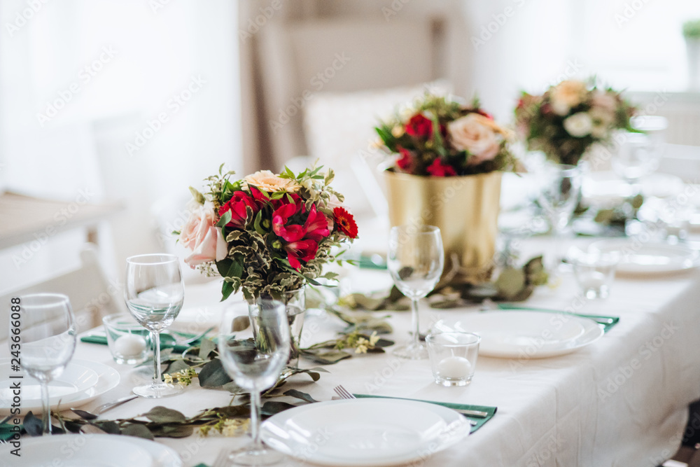 Table set for a meal indoors in a room on a party, a wedding or family celebration. Table set for a meal indoors in a room on a party, a wedding or family celebration.
