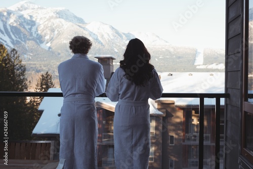 Couple looking at view from balcony