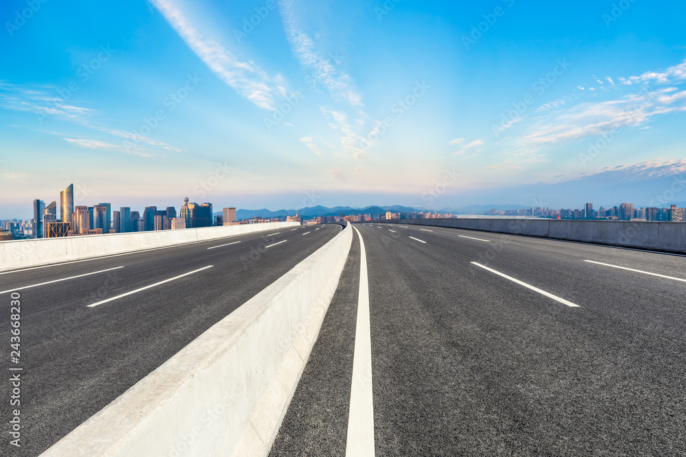 Fototapeta premium Empty asphalt road and city skyline at sunrise in hangzhou,high angle view