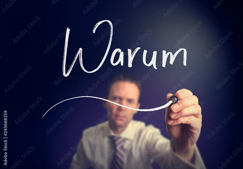 A businessman writing a Why A businessman writing a Why