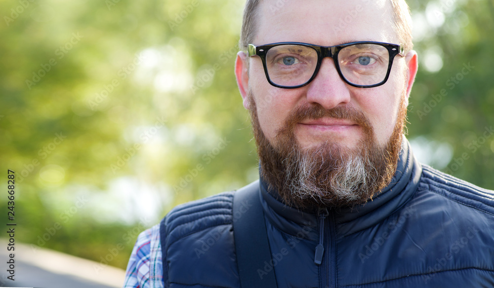 Portrait of a man with a beard with glasses. Close up male face. Portrait of a man with a beard with glasses. Close up male face.