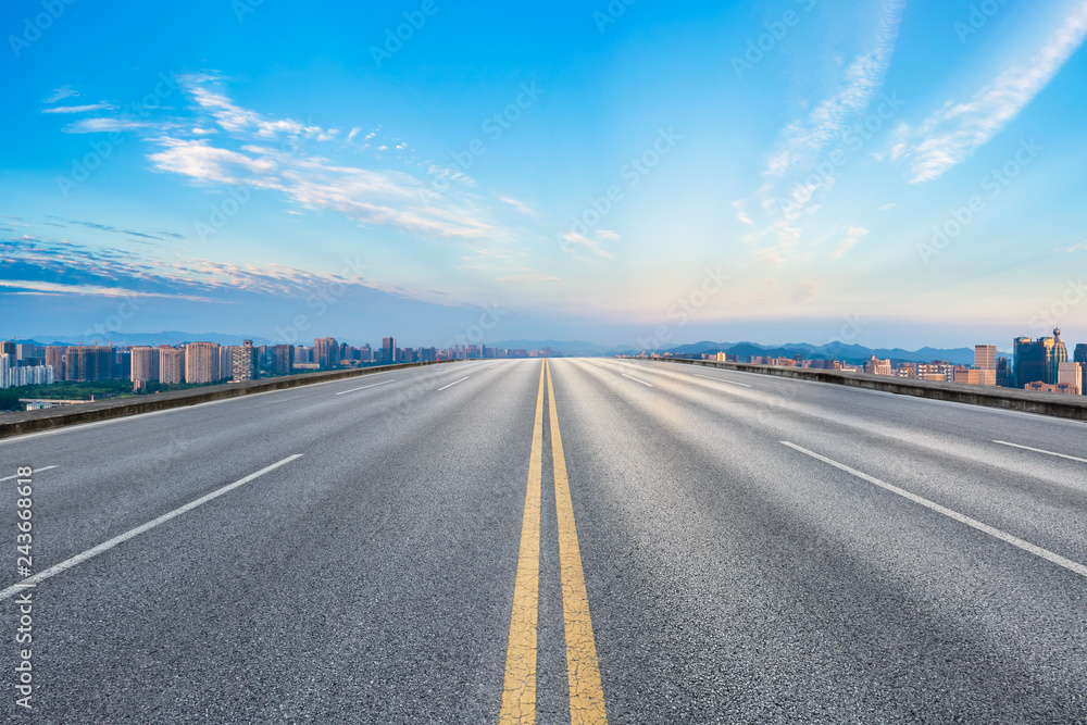 Fototapeta premium Empty asphalt road and city skyline at sunrise in hangzhou,high angle view