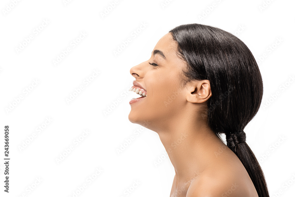 side view of happy young african american woman with closed eye laughing isolated on white side view of happy young african american woman with closed eye laughing isolated on white