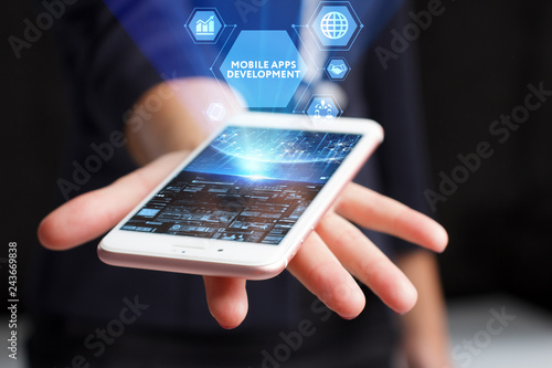 The concept of business, technology, the Internet and the network. A young entrepreneur working on a virtual screen of the future and sees the inscription: Mobile apps development