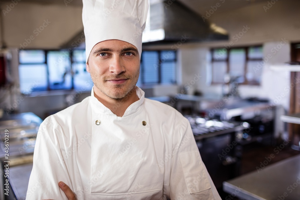 Male chef standing in kitchen at hotel