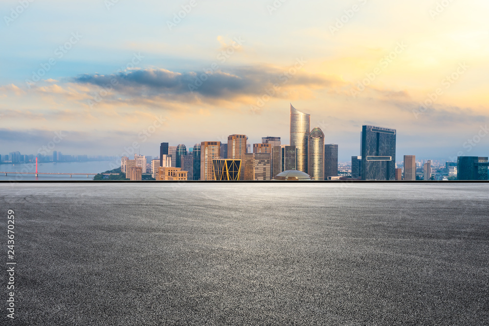 Empty asphalt road and city skyline at sunrise in hangzhou,high angle view Empty asphalt road and city skyline at sunrise in hangzhou,high angle view
