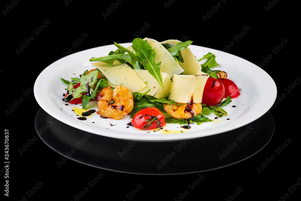 Salad with shrimp and cheese on black background Salad with shrimp and cheese on black background