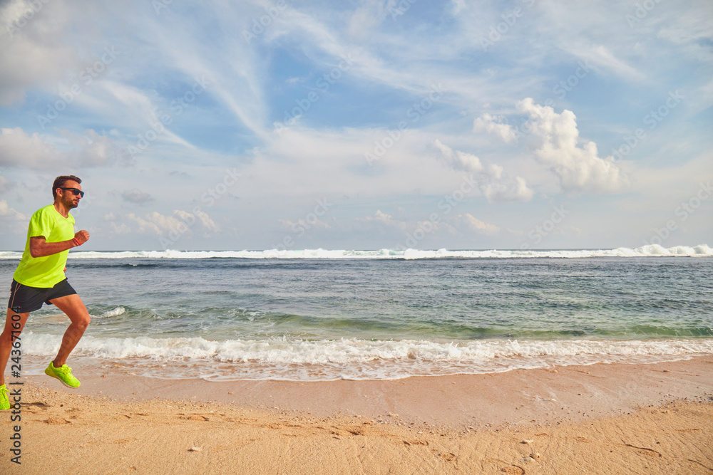 Man running / jogging on a tropical exotic beach. Man running / jogging on a tropical exotic beach.