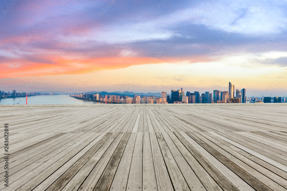 Wooden square and city skyline at sunrise in hangzhou,high angle view
