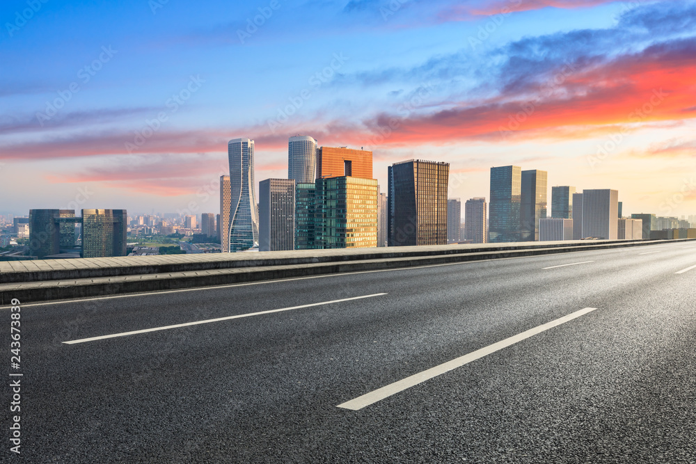 Empty asphalt road and city skyline in Hangzhou at sunrise,high angle view Empty asphalt road and city skyline in Hangzhou at sunrise,high angle view
