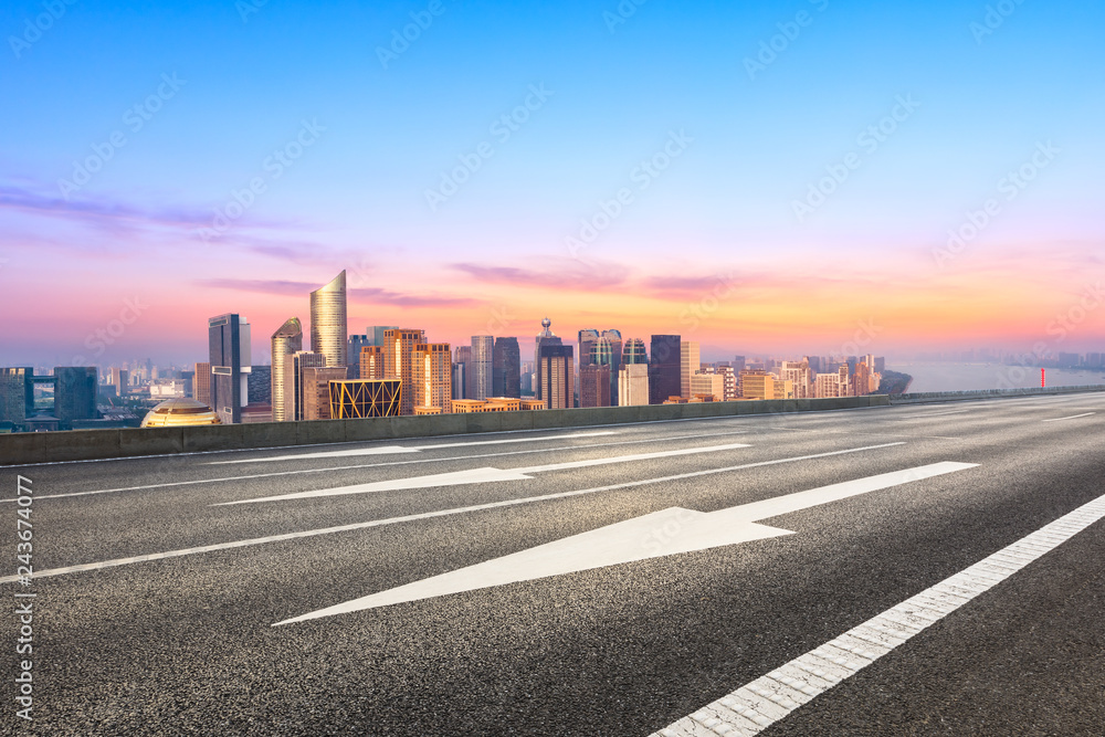 Empty asphalt road and city skyline in Hangzhou at sunrise,high angle view