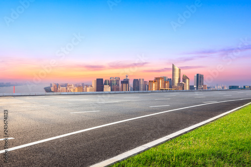 Empty asphalt road and city skyline in Hangzhou at sunrise high angle view