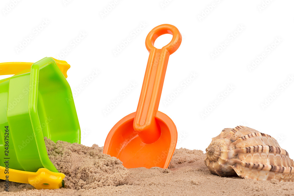 Bucket and shovel toys at the beach, isolated on white background. Copy space for your text or your image. Bucket and shovel toys at the beach, isolated on white background. Copy space for your text or your image.