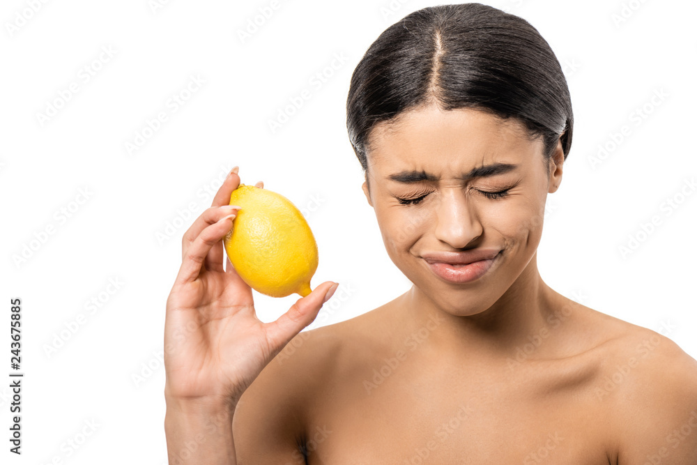 young naked african american woman with closed eyes holding lemon and frowning isolated on white young naked african american woman with closed eyes holding lemon and frowning isolated on white