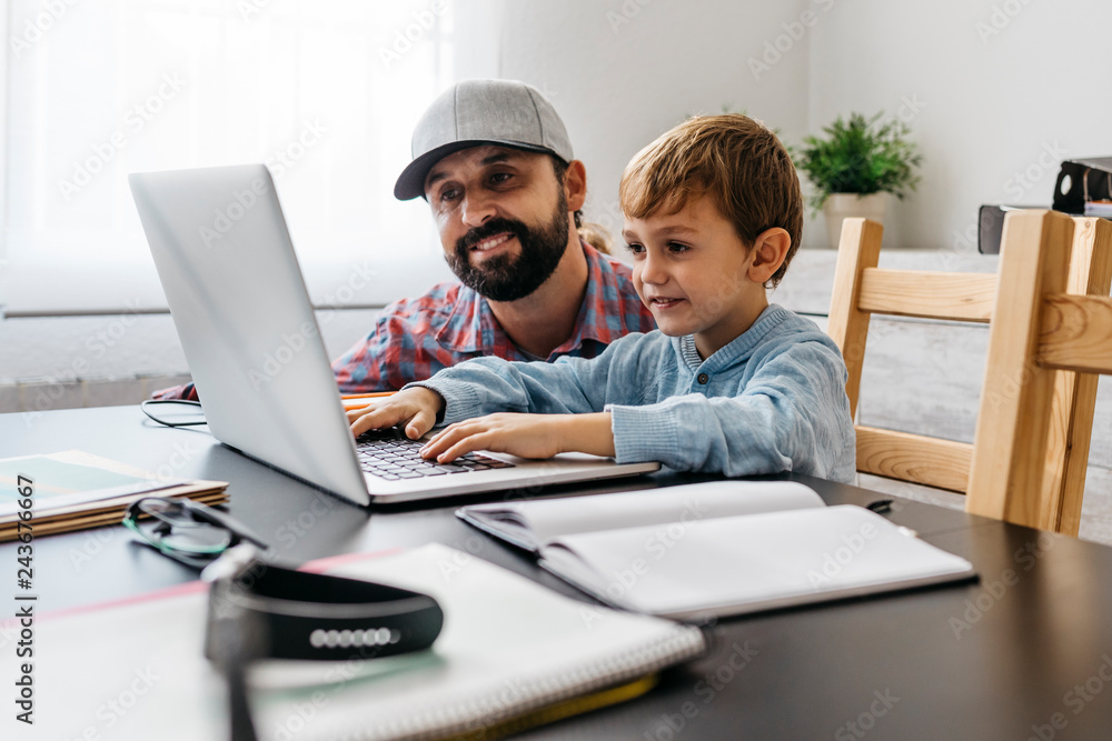 Father and son using laptop together Father and son using laptop together