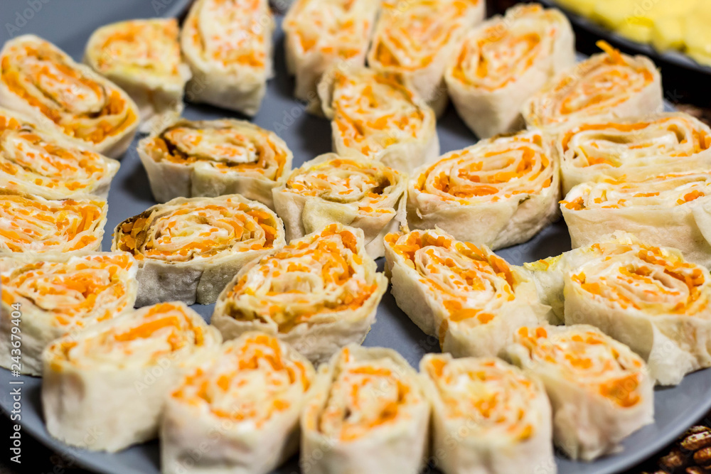 Snack roll of pita bread with Korean carrots on plate Snack roll of pita bread with Korean carrots on plate
