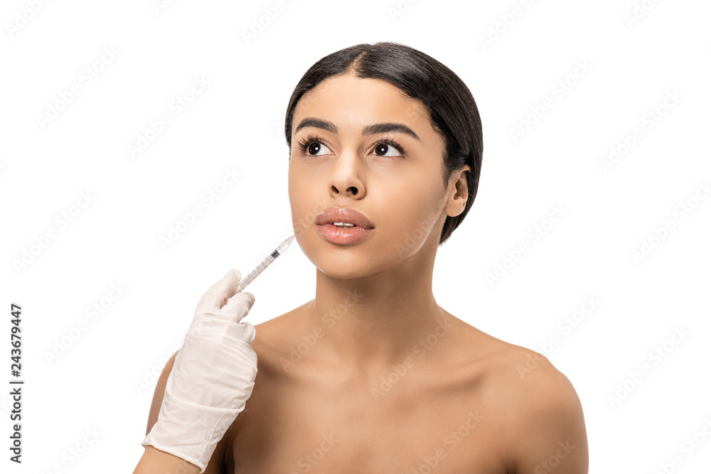 cropped shot of cosmetologist in latex glove giving beauty injection to naked young african american woman isolated on white cropped shot of cosmetologist in latex glove giving beauty injection to naked young african american woman isolated on white