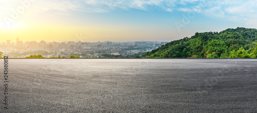 Fototapeta Naklejka Na Ścianę i Meble -  Panoramic city skyline and buildings with empty asphalt road at sunrise