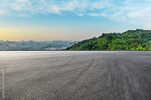 Fotografie, Tablou Panoramic city skyline and buildings with empty asphalt road at sunrise