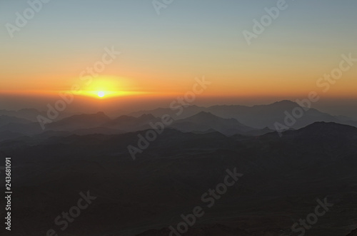Amazing golden sunrise in the mountains. White sun disk on the mountains. View from Mount Sinai  Mount Horeb  Gabal Musa  Moses Mount . Sinai Peninsula of Egypt