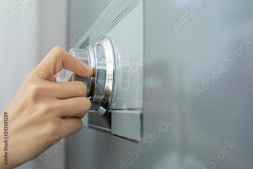 Hand of businesswoman opening code lock of her safe