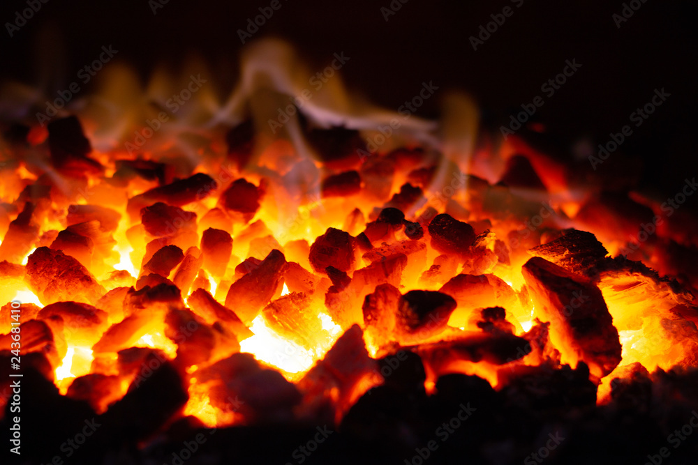 Abstract background of glowing coals in fireplace with fire flames