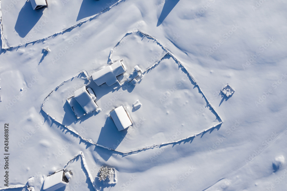 Snow covered remote village. Aerial view