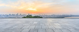 Panoramic city skyline and buildings with empty square floor at sunrise