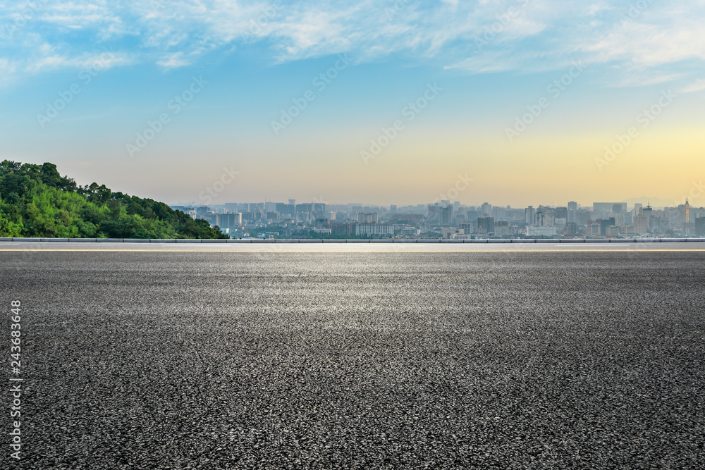 Fototapeta premium Panoramic city skyline and buildings with empty asphalt road at sunrise