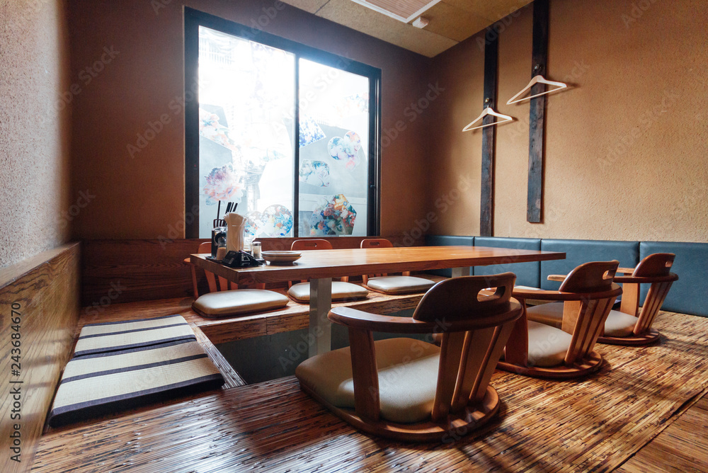 Japanese style ramen restaurant, Low table in center with seats on the