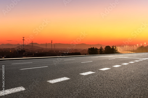 Asphalt road and hills at beautiful sunset