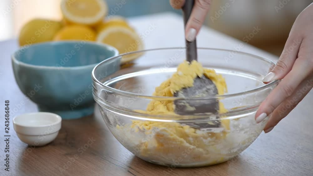 Women's hands knead the dough in the bowl. Women's hands knead the dough in the bowl.