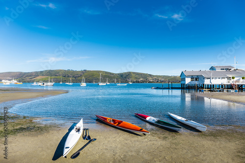 4 canoes docked with view of lake.