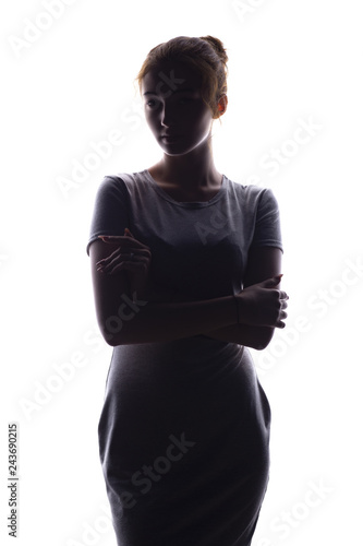 silhouette of a beautiful girl confidently looking forward, figure of young woman on a white isolated background