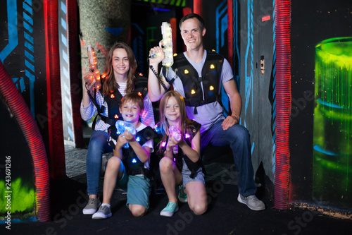 Kds and adults posing with laser guns