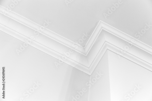 White interior with corner and ceiling baseboard