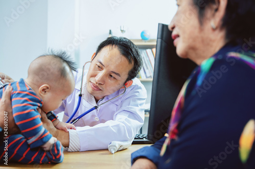 Doctor using stethoscope instrument to check baby in hospital