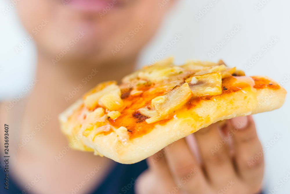 Cloes up Happy hungry young man eating a piece of pizza. Cloes up Happy hungry young man eating a piece of pizza.