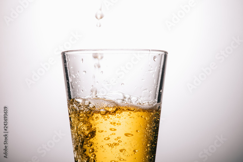 Wallpaper Mural close up of glass of tea and splashes on white background Torontodigital.ca