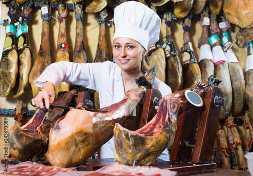 woman cutting dried ham © JackF
