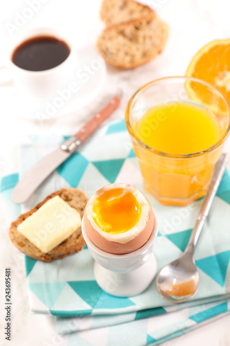 breakfast with boiled egg, coffee and orange juice