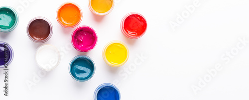 Obraz na plátně Multicolored gouache on a white background Isolated Paints in containers Top vie