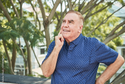 Portrait of pensive smiling man pondering over creative idea