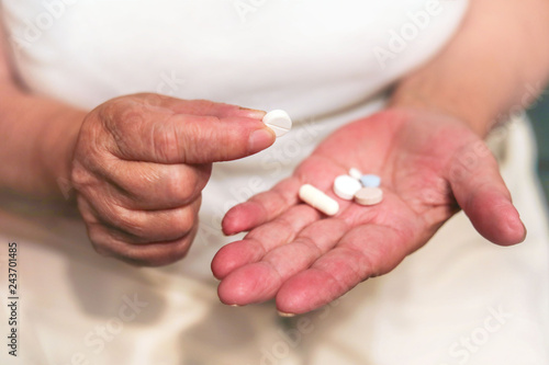 old hands holding pills in their hands  medicines in the hands of an elderly woman