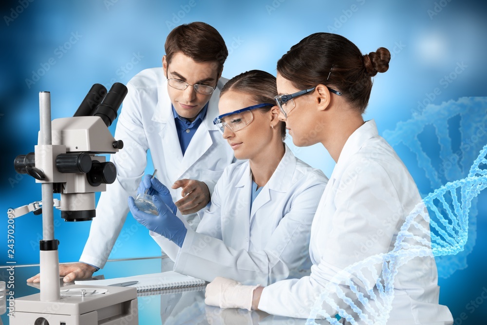 Female and male scientists in glasses working with microscope Female and male scientists in glasses working with microscope