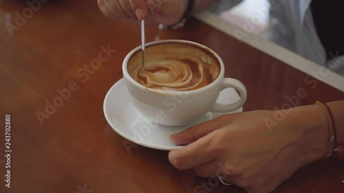 Two woman sharing coffee in cafe, close up shot on coffee cup