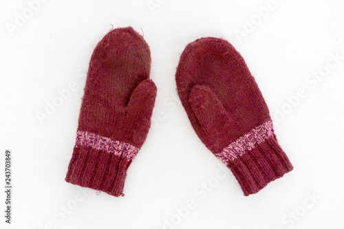 handmade red mittens on white snow