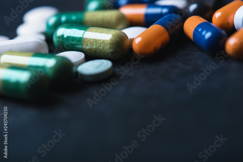  Pharmacy background on a black table. Tablets on a black background. Pills. Medicine and healthy. Close up of capsules. Different kind of pills 