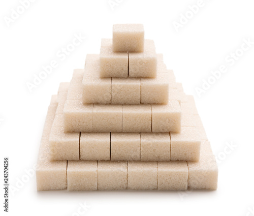 Pyramid made of sugar cubes on white background